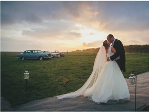 Devon field, married couple, cars, sunset