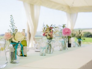 clear span marquees, table, bottles, flowers