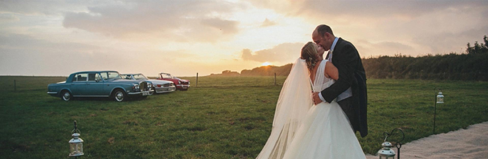 Devon field, married couple, cars, sunset